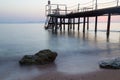 Misty dawn over the sea beach. Stairs to the sea Royalty Free Stock Photo