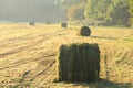 Misty day and bales of hay in the park in the autumn. Royalty Free Stock Photo