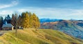 Misty early daybreak in autumn mountain and wooden chapel on mountain top (Jasynja Village, Carpathian Royalty Free Stock Photo