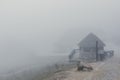 Misty and foggy landscape in the mountain with a hut in the path. autumn or winter season - Image Royalty Free Stock Photo
