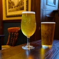 Misty glasses with two pints of cold Scotch ale, amber pale ale, lager draft beer in English pub