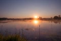 Misty Golden Sunrise Reflecting over Lake in Spring Royalty Free Stock Photo