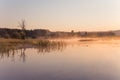 Misty Golden Sunrise Reflecting over Lake in Spring Royalty Free Stock Photo