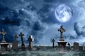 Misty Graveyard With Old Creepy Headstones Under Moon On Halloween