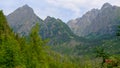 Misty horizons blue tones. Mountain landscape with huge rocky slopes of High Tatras and evergreen forest, Slovakia.