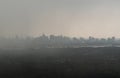 Misty Landscape of city skyscrapers covered before raining. Heavy dense smog fot during afternoon that Bangkok city cannot be seen