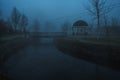 misty landscape with a gazebo by river on an autumn morning in the fog mist Royalty Free Stock Photo