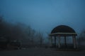 misty landscape with a gazebo by river on an autumn morning in the fog mist Royalty Free Stock Photo