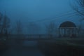 misty landscape with a gazebo by river on an autumn morning in the fog mist Royalty Free Stock Photo