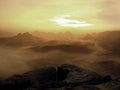 Misty melancholic morning. View over birch tree to deep valley full of heavy mist.