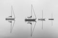 Misty Morning with Boats and Reflections on the Bay in Black and White Royalty Free Stock Photo