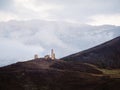 Misty morning in the Caucasus mountains. Medieval tower on foggy mountain slope background. Ingushetia region Royalty Free Stock Photo