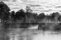 Misty morning, grayscale photography of bridge, lake and mist.