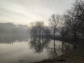 Misty morning on the lake - crepuscular light at sunrise Royalty Free Stock Photo