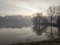 Misty morning on the lake - crepuscular light at sunrise Royalty Free Stock Photo