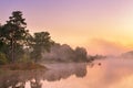 Misty morning on the lake. Fishing boat at a foggy river Royalty Free Stock Photo