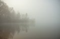 Misty morning on the lake. Gazebo or hunting lodge in the forest by the lake. Royalty Free Stock Photo