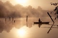 A misty morning by the lake. Small fishing boat at the lake. Royalty Free Stock Photo