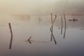 A misty morning by the lake. Small fishing boat at the lake. Royalty Free Stock Photo