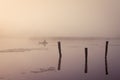 A misty morning by the lake. Small fishing boat at the lake. Royalty Free Stock Photo