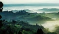 Misty morning landscape, sunrise over hills in Tuscany with garden trees, green hills. Fog in Italian countryside Royalty Free Stock Photo