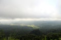 Misty morning in the mountains. Gloomy sky over the forest. Green nature landscape background. Royalty Free Stock Photo