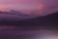 Misty morning nature view in the mountains at sunrise. Natural abstract art background in light pink purple color. Royalty Free Stock Photo