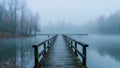 A misty morning over the lake with an old wooden bridge