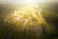 Misty morning river in sunlight. River landscape aerial view. Riverside view from above. Summer nature in sun rays. Drone view on