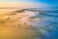 Misty morning river in sunlight. River landscape aerial view. Riverside view from above. Summer nature in sun rays. Drone view on Royalty Free Stock Photo