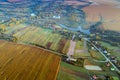 Aerial view from above at village, river and arable fields