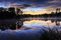 Misty morning sunrise reflection in a lake