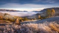 Misty morning in Transylvania with haystacks in autumn frosty morning ,country side in Romanian Mountains