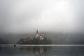 Misty Morning view of famous lake Bled and small island with a church Royalty Free Stock Photo