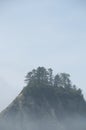 Misty Mountain with Forest on the seashore at Rialto Beach. Olympic National Park, WA Royalty Free Stock Photo