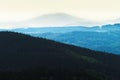 Misty mountain landscape of Stone Mountains in the Sudetes and distant Sleza summit silhouette, Lower Silesia, Poland. Royalty Free Stock Photo