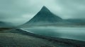 Misty mountain peak overlooking tranquil lake Royalty Free Stock Photo