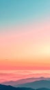 Misty Mountain Range at Sunrise with Gradient Sky and Pink and Blue Hues Royalty Free Stock Photo