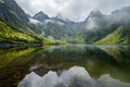 Misty mountain reflections in calm water, evoking a sense of mystery and introspection. Personal viewpoint