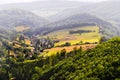 Misty mountain valley with fields and meadows. Scenic picturesque farmland landscape. Royalty Free Stock Photo