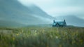 The misty mountains blur into a tranquil backdrop enhancing the peaceful solitude of this defocused image of a remote