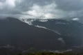 Misty mountains with dramatic cloudy sky at morning in rainy day Royalty Free Stock Photo