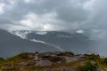 Misty mountains with dramatic cloudy sky at morning in rainy day Royalty Free Stock Photo