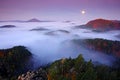 Misty night landscape with moon. Czech autumn landscape. Hills and villages with foggy morning. Morning fall valley of Bohemian Sw