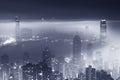 Misty night view of Victoria harbor in Hong Kong city Royalty Free Stock Photo