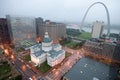 In a misty rain an elevated view of Gateway Arch and the historical Old St. Louis Courthouse. The Courthouse was constructed of b