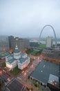 In a misty rain an elevated view of Gateway Arch and the historical Old St. Louis Courthouse. The Courthouse was constructed of b Royalty Free Stock Photo