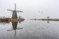 Misty and rainy windmill sunrise Royalty Free Stock Photo