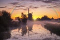 Misty and rainy windmill warm sunrise Royalty Free Stock Photo