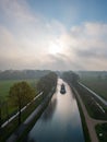 Misty River Journey at Dawn with Sun Peeking Through Royalty Free Stock Photo